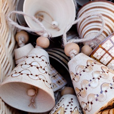 Ceramic bells in a basket at the fair clipart