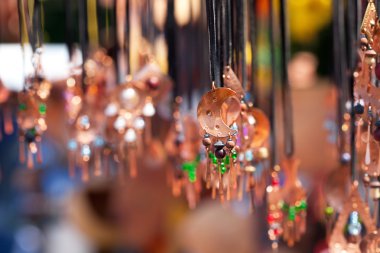 Clay ornaments on the ropes at the fair clipart