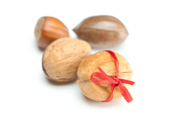 Cake nut and ribbon isolated on white — Stock Photo, Image