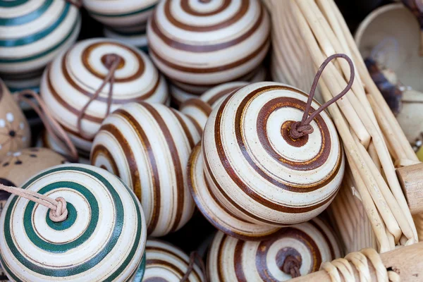 Ceramic bells in a basket at the fair — Stock Photo, Image