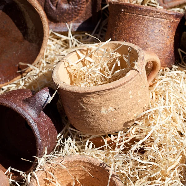 Clay pots in the straw at the fair — Stock Photo, Image