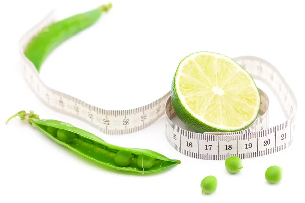 Lime,peas and measure tape isolated on white — Stock Photo, Image