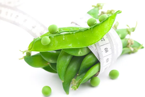 Peas and measure tape isolated on white — Stock Photo, Image