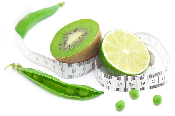 Lime,peas,kiwi and measure tape isolated on white — Stock Photo, Image