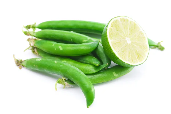 Peas and lime isolated on white — Stock Photo, Image