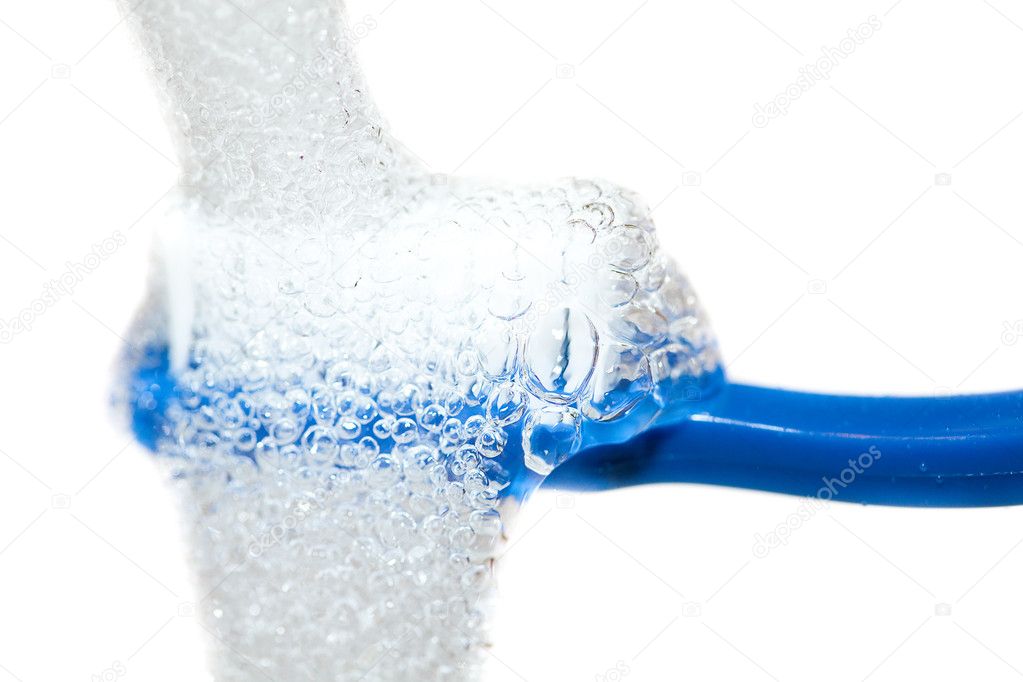 Blue toothbrush under running water