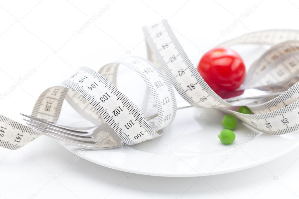 Tomato,peas on plate and measure tape isolated on white