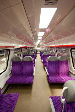 Salon of high speed train at a railway station clipart