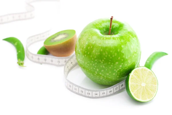 Äpple, lime, ärter, kiwi och mått band isolerad på vit — Stockfoto