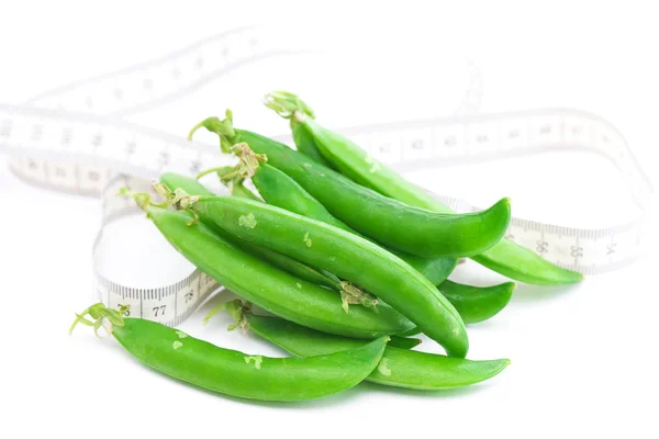 Peas and measure tape isolated on white — Stock Photo, Image