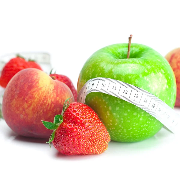Big juicy red ripe strawberries,apple,peas,peach and measure tap — Stock Photo, Image