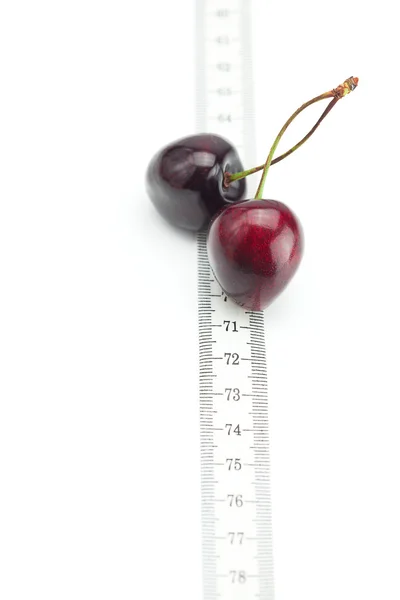 Measure tape and cherry isolated on white — Stock Photo, Image