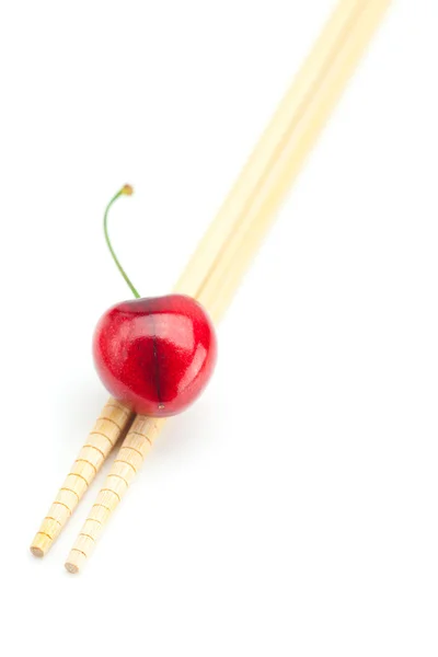 Cherry and chopsticks isolated on white — Stock Photo, Image