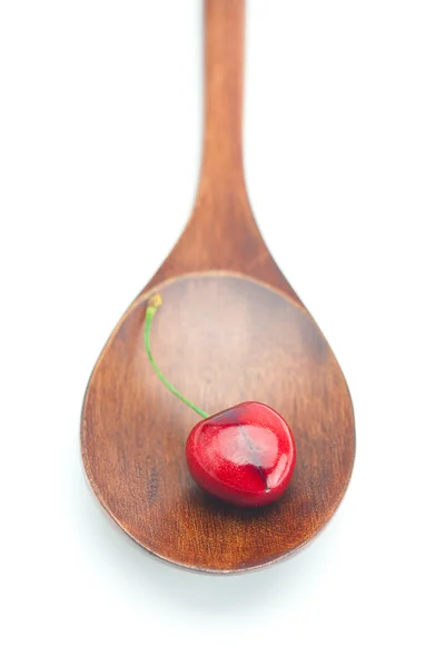 Cucchiaio di legno e ciliegia isolato su bianco — Foto Stock