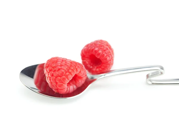 Spoon and raspberries isolated on white — Stock Photo, Image
