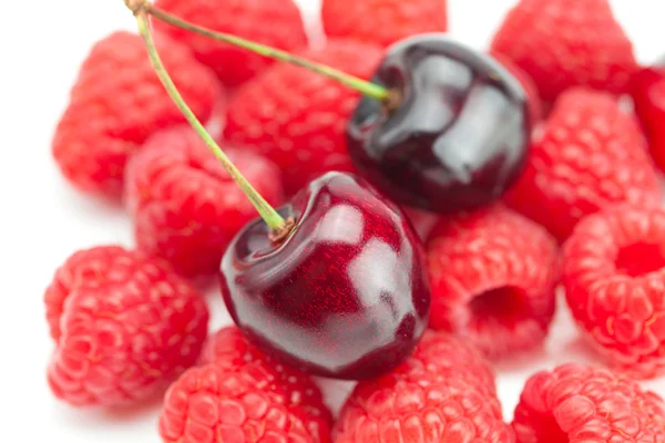 Cherry on a background of raspberry — Stock Photo, Image