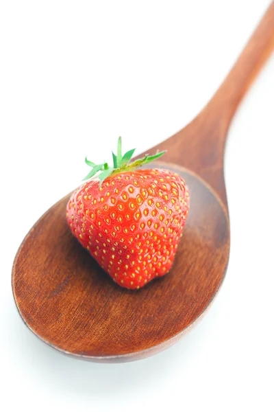 Wooden spoon and strawberry isolated on white — Stock Photo, Image