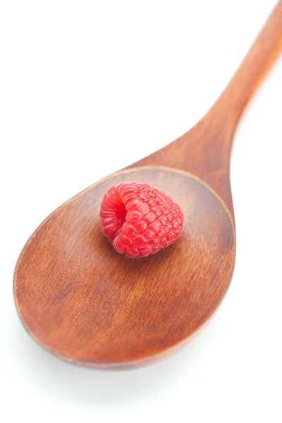 Wooden spoon and raspberries isolated on white — Stock Photo, Image