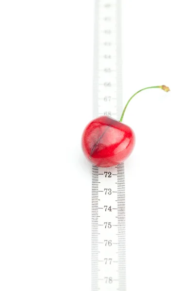 Measure tape and cherry isolated on white — Stock Photo, Image