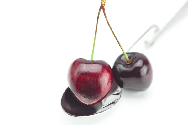 Spoon and cherry isolated on white — Stock Photo, Image