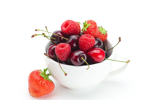 Raspberries, strawberries and cherries in a bowl isolated on whi — Stock Photo, Image