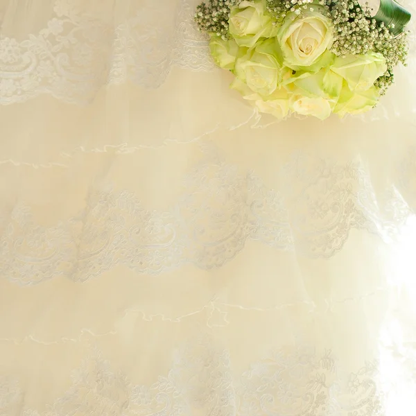 Kytice v ruce nevěsty na pozadí dres — Stock fotografie