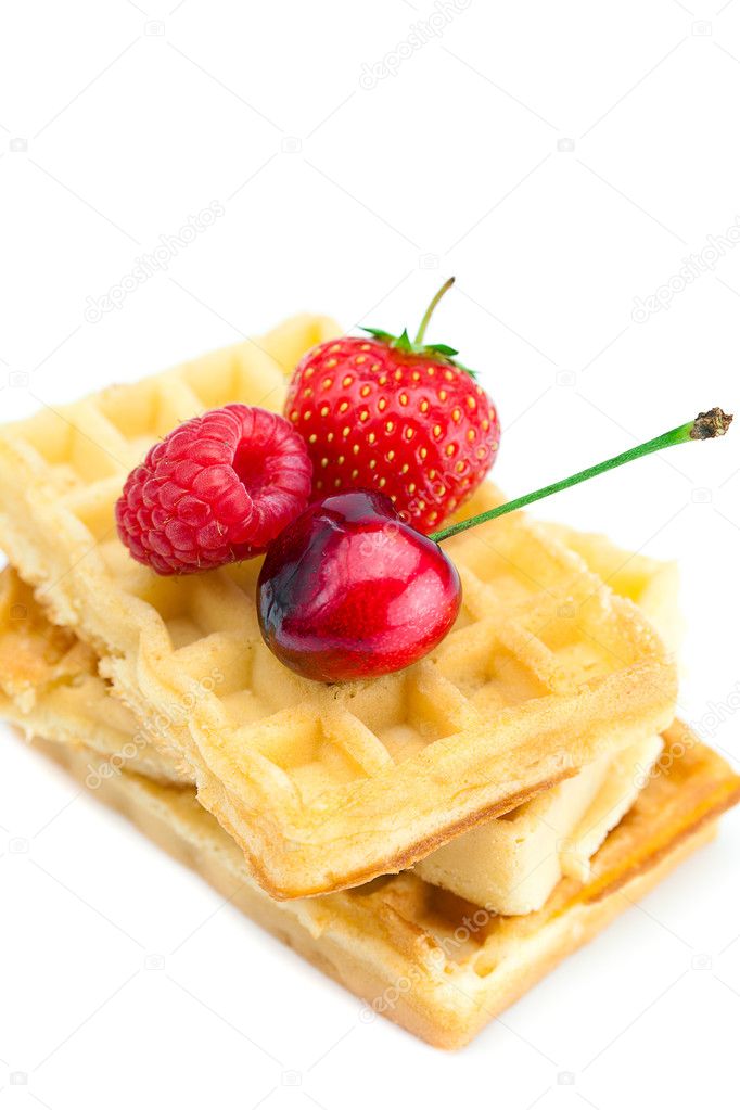 Waffles, cherries, strawberries and raspberries isolated on whit