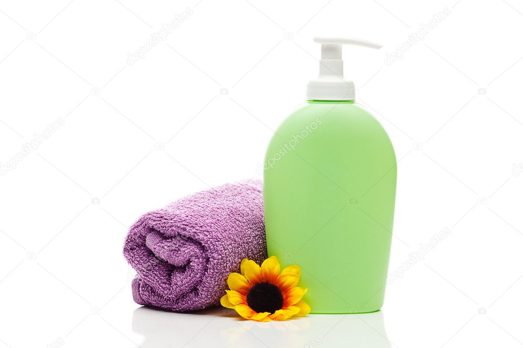 Cosmetic containers, towel and flower isolated on white