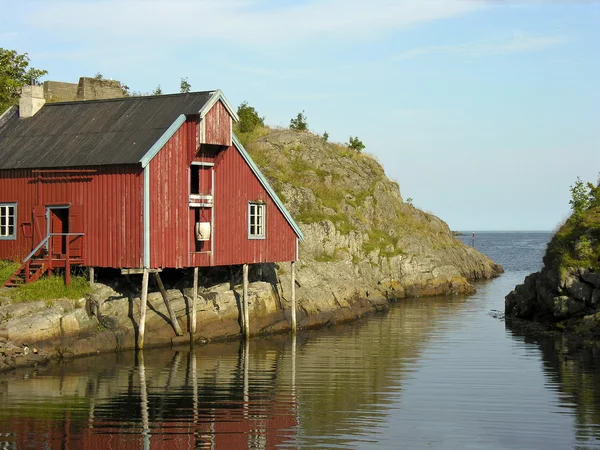 Rode huis over een rivier — Stockfoto