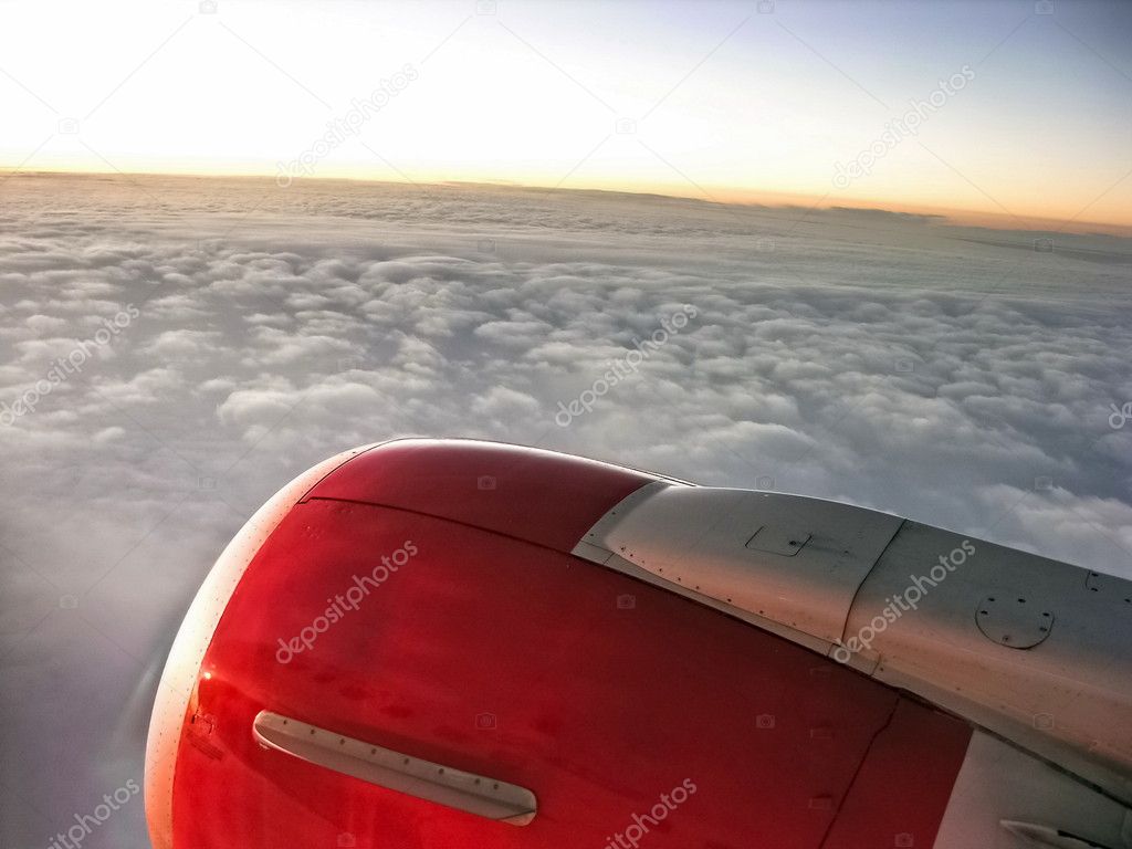 Airplane engine in sunset sky