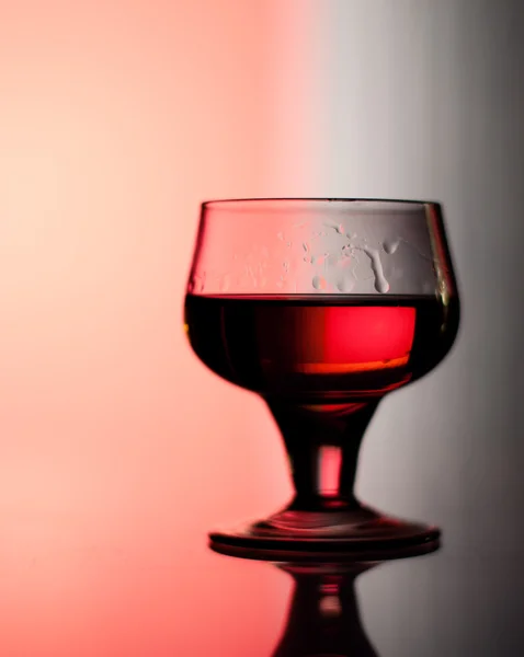 Cognac glass backlit by red and blue — Stock Photo, Image