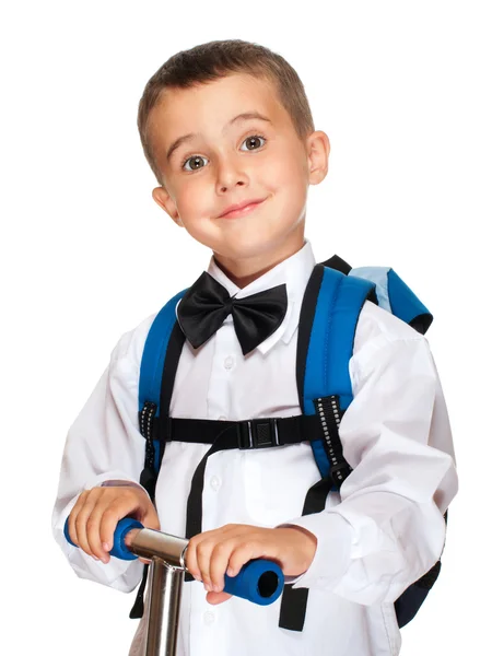 Elementary student boy with backpack and scooter — Stock Photo, Image