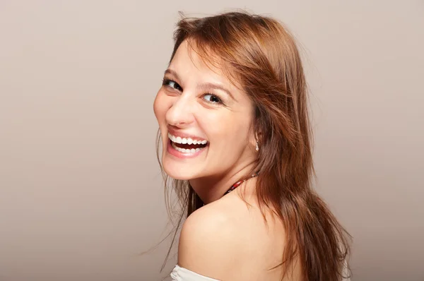 Portrait of laughing redhead woman turning around — Stock Photo, Image