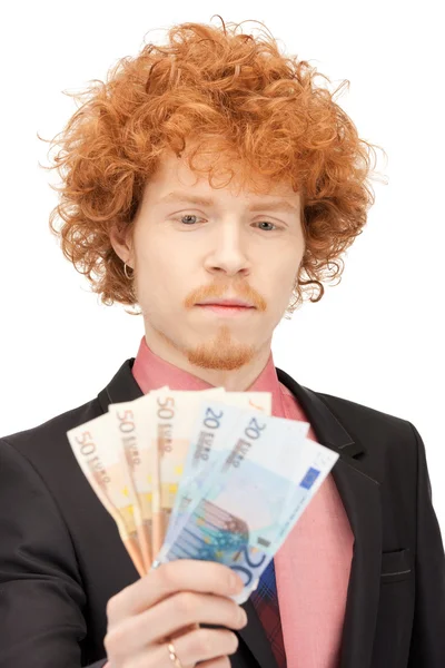 Hombre guapo con dinero en efectivo en euros —  Fotos de Stock