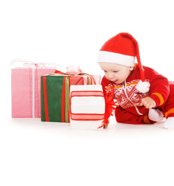 Santa pomocníka dítě s vánoční dárky — Stock fotografie