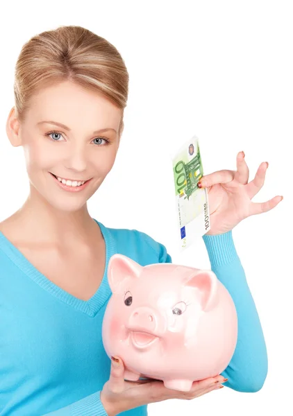 Lovely woman with piggy bank and money Royalty Free Stock Images