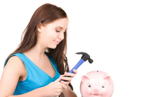 Teenage girl with piggy bank and hammer Stock Picture