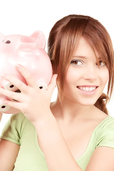 Lovely teenage girl with piggy bank Royalty Free Stock Images