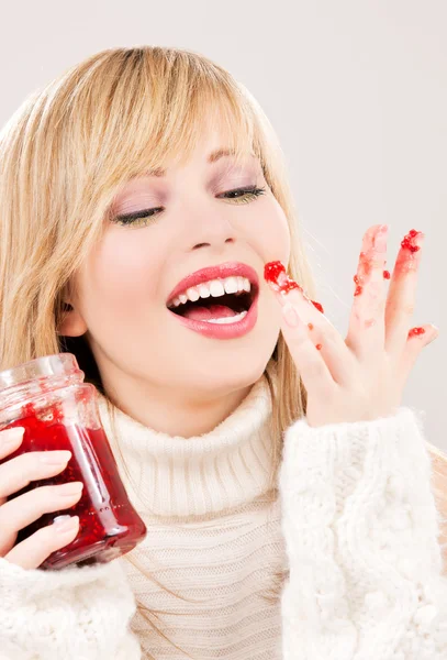 Happy teenage girl with raspberry jam — Stock Photo, Image