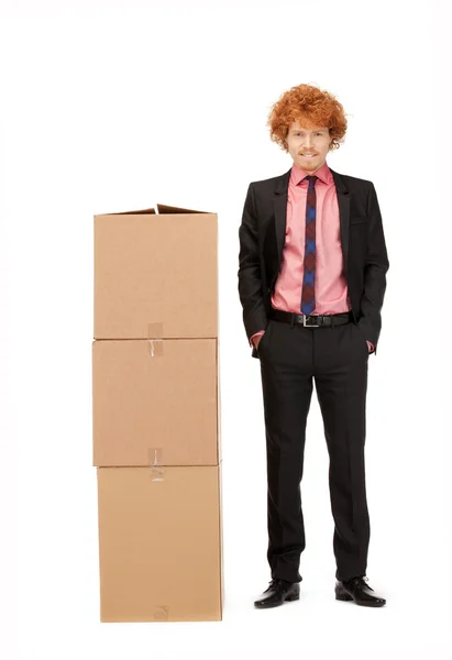 Attractive businessman with big boxes — Stock Photo, Image
