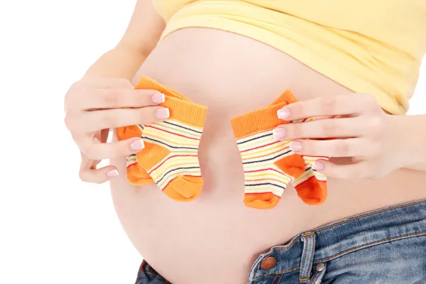 Gravid kvinna mage och dubbla strumpor — Stockfoto