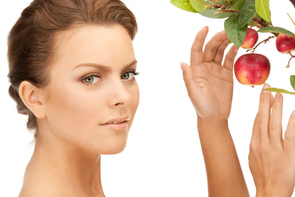 Lovely woman with apple twig Stock Image