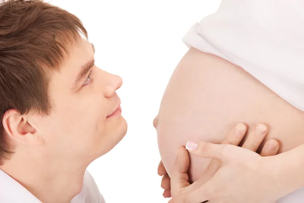 Мужское лицо и беременная женщина живот — стоковое фото