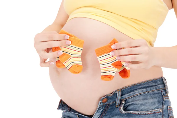 Mujer embarazada vientre y calcetines gemelos —  Fotos de Stock
