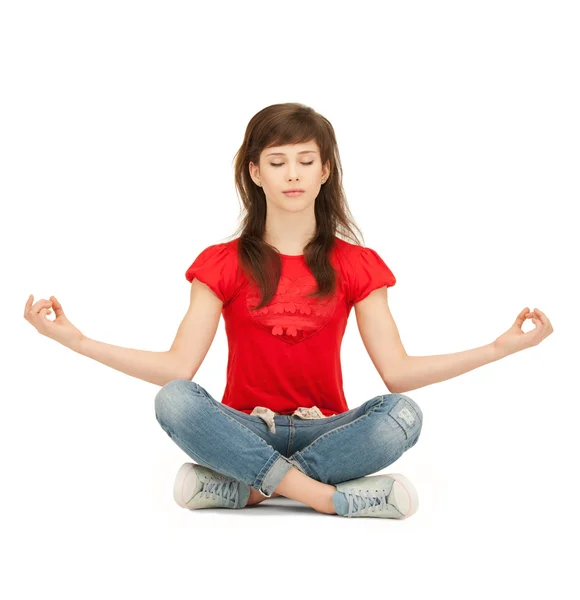 Calm attractive teenage girl in lotus pose — Stock Photo, Image