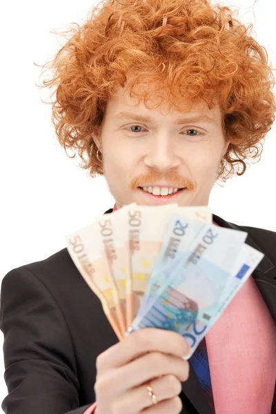 Красивый человек с евро наличными деньгами — стоковое фото