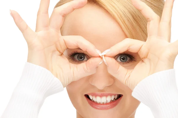 Lovely woman looking through hole from fingers — Stock Photo, Image