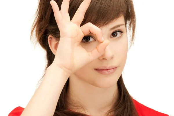 Teenage girl looking through hole from fingers — Stock Photo, Image