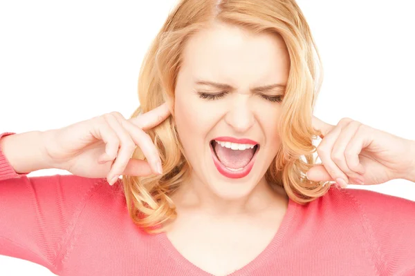 Woman with fingers in ears Stock Picture