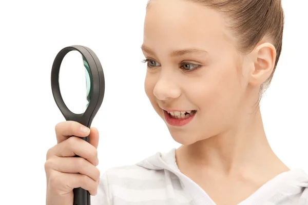 Teenage girl with magnifying glass — Stock Photo, Image